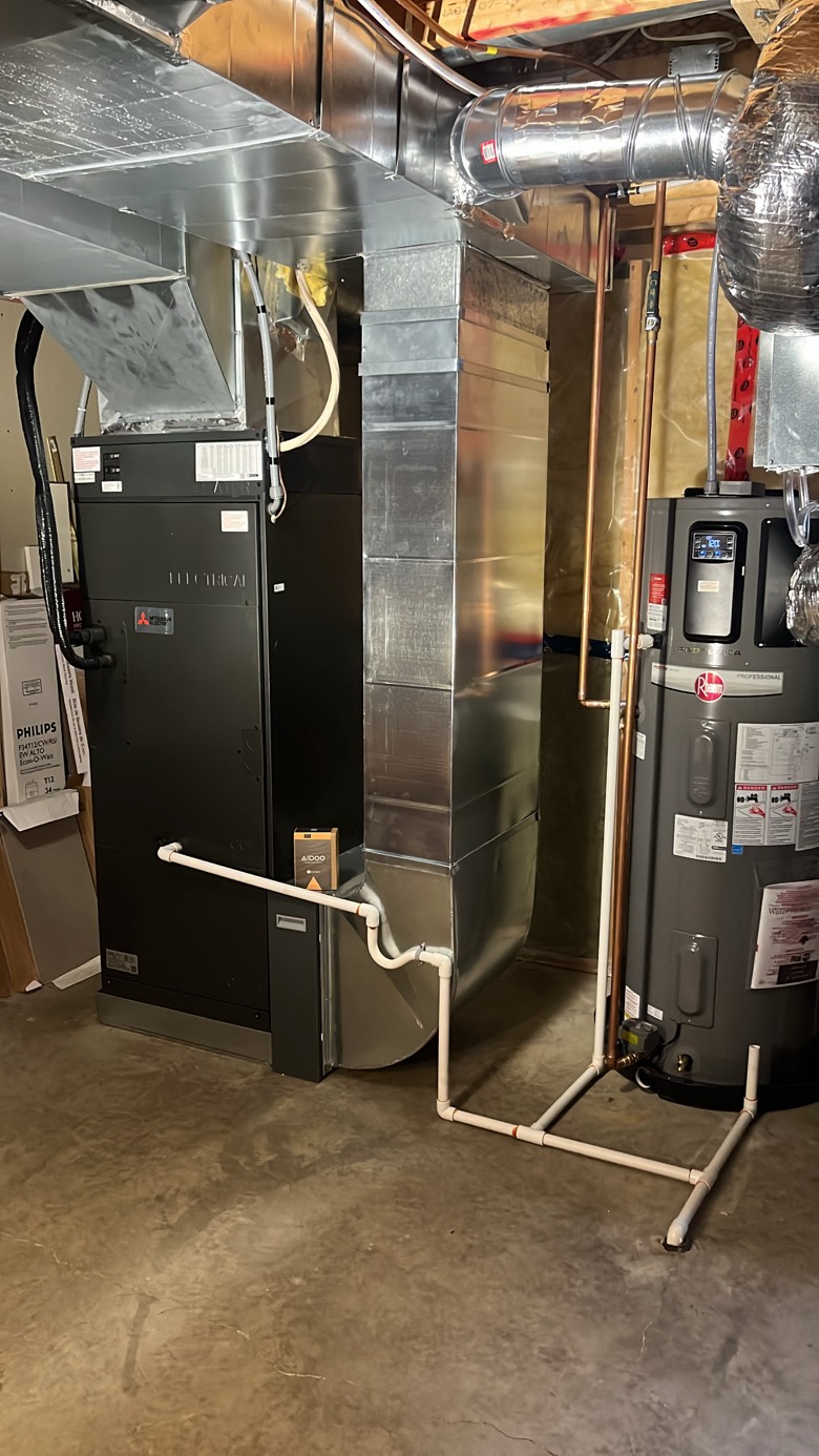 Basement HVAC installation showing Mitsubishi air handler, ductwork, and Rheem water heater in Ottawa home