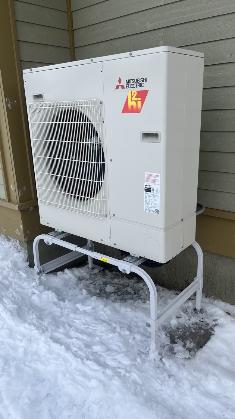 Mitsubishi Hyper-Heating H2i outdoor unit operating in winter snow conditions