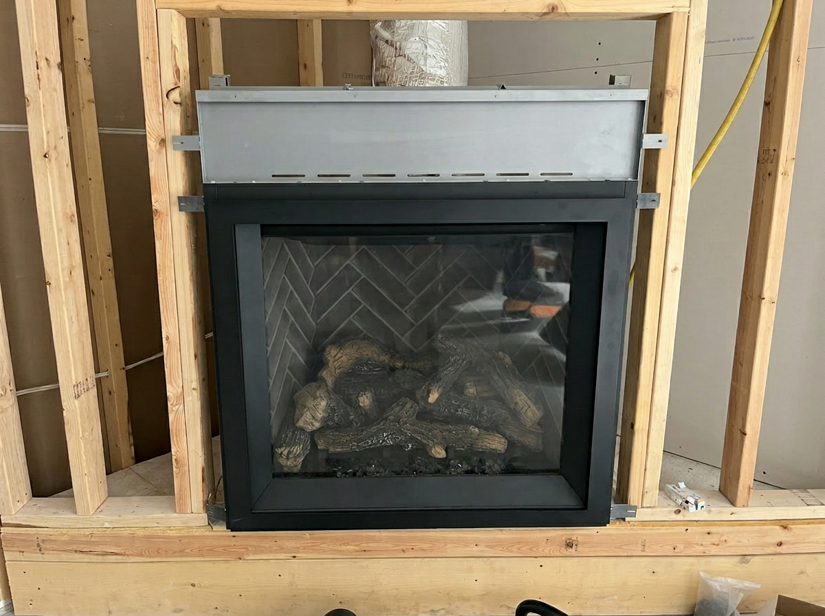Gas fireplace insert being installed in wood framing during new construction by Comfort Tech Ottawa