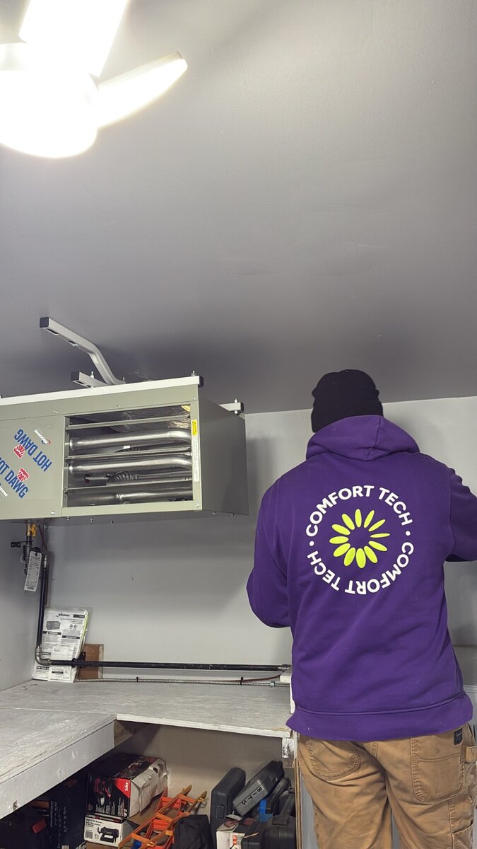 Comfort Tech installer servicing a Hot Dawg garage heater unit