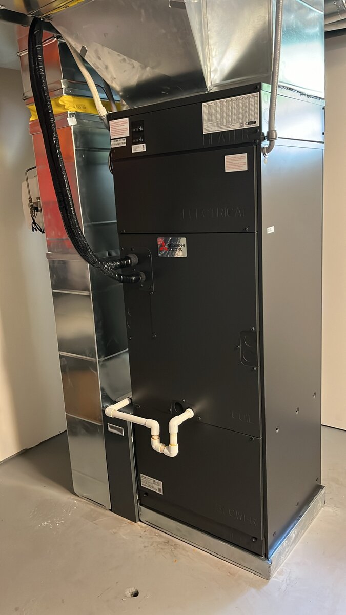 Mitsubishi Electric air handler close-up showing electrical and blower sections