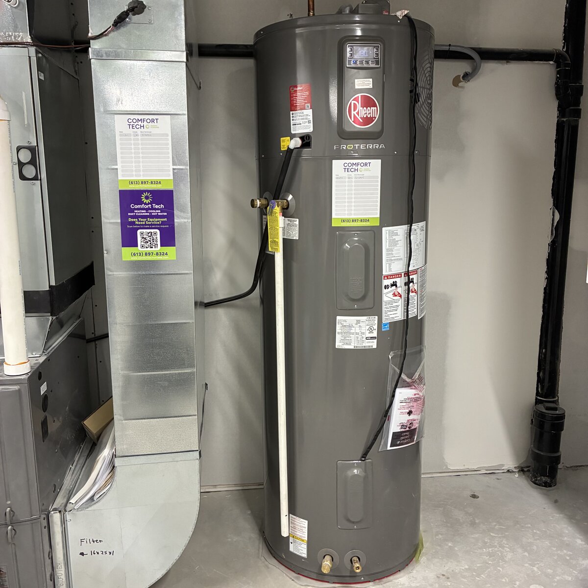 Rheem ProTerra hybrid heat pump water heater installed by Comfort Tech with service stickers